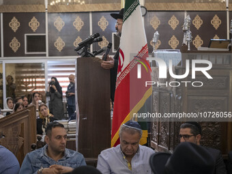 Rabbi Younes Hamami Lalehzar (top), Leader of Iranian Jews, delivers a speech as he stands next to an Iran flag at a synagogue in downtown T...