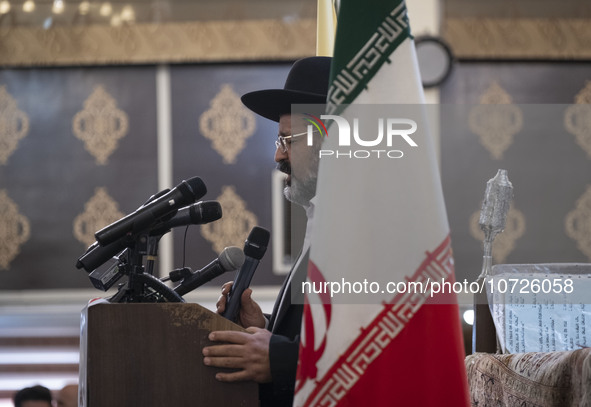 Rabbi Younes Hamami Lalehzar, Leader of Iranian Jews, delivers a speech as he stands next to an Iran flag at a synagogue in downtown Tehran...