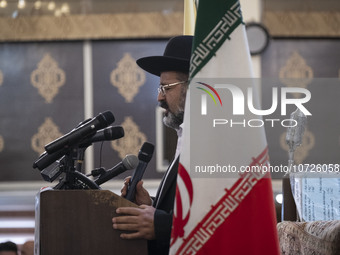 Rabbi Younes Hamami Lalehzar, Leader of Iranian Jews, delivers a speech as he stands next to an Iran flag at a synagogue in downtown Tehran...