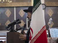 Rabbi Younes Hamami Lalehzar, Leader of Iranian Jews, delivers a speech as he stands next to an Iran flag at a synagogue in downtown Tehran...