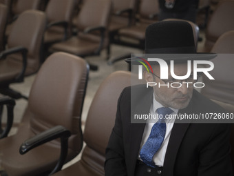 An unidentified Jewish Rabbi, looks on while sitting at a synagogue in downtown Tehran during a gathering to protest against Israeli attacks...