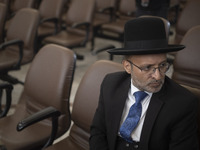 An unidentified Jewish Rabbi, looks on while sitting at a synagogue in downtown Tehran during a gathering to protest against Israeli attacks...