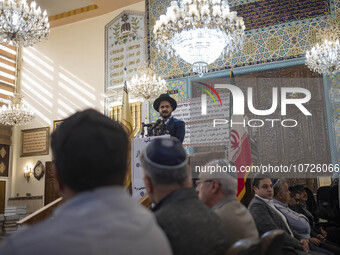 A Jewish Rabbi (C), speaks at a synagogue in downtown Tehran during a gathering to protest against Israeli attacks on Palestinian civilians,...