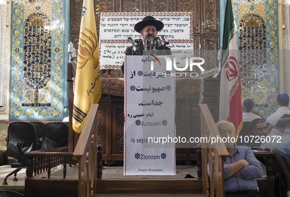 Rabbi Younes Hamami Lalehzar (C), Leader of Iranian Jews, delivers a speech as he stands next to an Iran flag at a synagogue in downtown Teh...