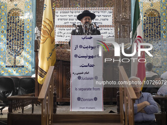 Rabbi Younes Hamami Lalehzar (C), Leader of Iranian Jews, delivers a speech as he stands next to an Iran flag at a synagogue in downtown Teh...