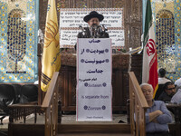 Rabbi Younes Hamami Lalehzar (C), Leader of Iranian Jews, delivers a speech as he stands next to an Iran flag at a synagogue in downtown Teh...