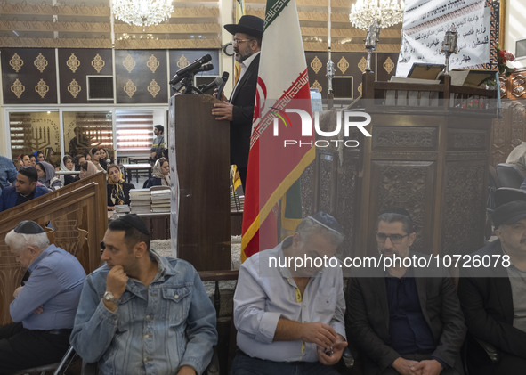 Rabbi Younes Hamami Lalehzar (top), Leader of Iranian Jews, delivers a speech as he stands next to an Iran flag at a synagogue in downtown T...