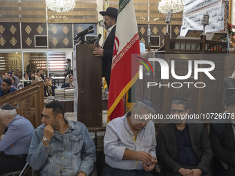 Rabbi Younes Hamami Lalehzar (top), Leader of Iranian Jews, delivers a speech as he stands next to an Iran flag at a synagogue in downtown T...