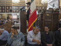 Rabbi Younes Hamami Lalehzar (top), Leader of Iranian Jews, delivers a speech as he stands next to an Iran flag at a synagogue in downtown T...