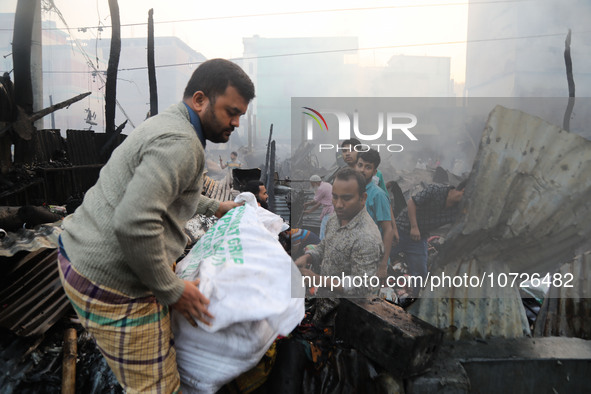 Traders are currently attempting to salvage some of the unburnt textile products from their shop following a fire in Baburhat, Narsingdi, Ba...