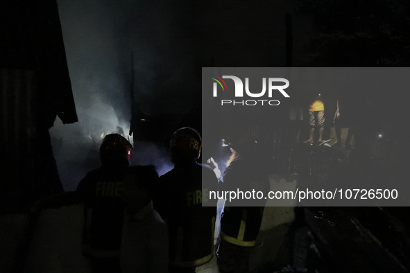 Fire service personnel from Bangladesh are extinguishing a fire that erupted in Baburhat, Narsingdi, Bangladesh, on October 30, 2023. This a...