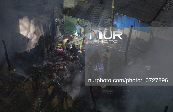 Bangladeshi fire fighters try to extinguish a fire that broke out Baburhat, Narsingdi on October 30, 2023, which is one of the biggest tradi...