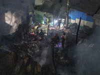 Bangladeshi fire fighters try to extinguish a fire that broke out Baburhat, Narsingdi on October 30, 2023, which is one of the biggest tradi...