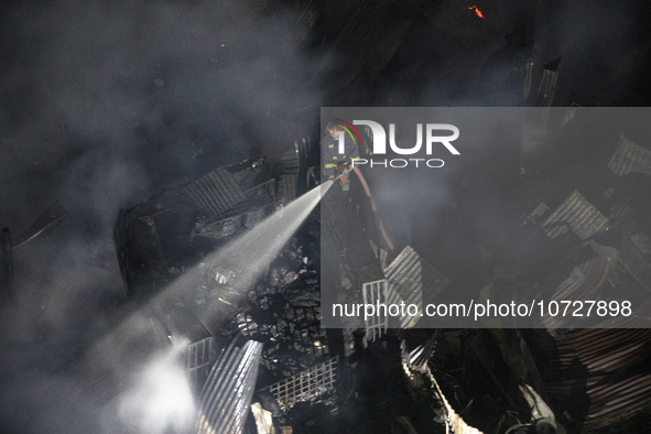 Bangladeshi fire fighters try to extinguish a fire that broke out Baburhat, Narsingdi on October 30, 2023, which is one of the biggest tradi...