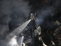 Bangladeshi fire fighters try to extinguish a fire that broke out Baburhat, Narsingdi on October 30, 2023, which is one of the biggest tradi...