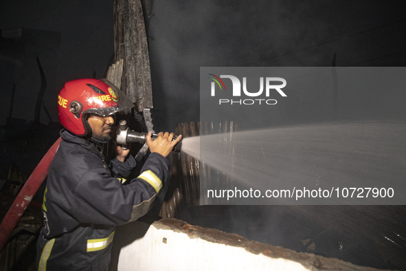 Bangladeshi fire fighters try to extinguish a fire that broke out Baburhat, Narsingdi on October 30, 2023, which is one of the biggest tradi...