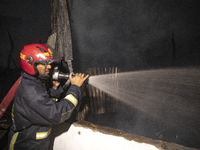 Bangladeshi fire fighters try to extinguish a fire that broke out Baburhat, Narsingdi on October 30, 2023, which is one of the biggest tradi...