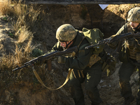 Servicemen of the First Presidential National Guard Brigade of Ukraine BUREVIY (Storm) during a practical exercise at a training ground in n...