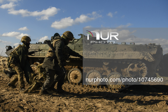 Servicemen of the First Presidential Brigade of the National Guard of Ukraine BUREVIY (Storm) practice evacuating a wounded soldier during a...