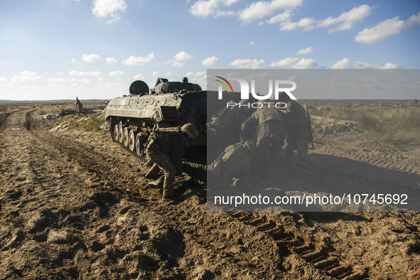 Servicemen of the First Presidential Brigade of the National Guard of Ukraine BUREVIY (Storm) practice evacuating a wounded soldier during a...