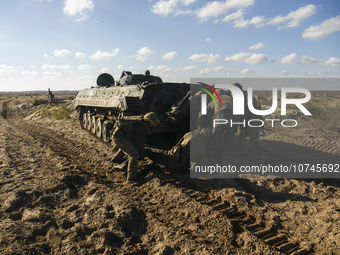 Servicemen of the First Presidential Brigade of the National Guard of Ukraine BUREVIY (Storm) practice evacuating a wounded soldier during a...