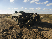 Servicemen of the First Presidential Brigade of the National Guard of Ukraine BUREVIY (Storm) practice evacuating a wounded soldier during a...