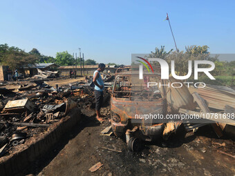 A resident looks at a charred vehicle after an inferno on the night of Diwali, the Hindu Festival of Light celebration, which gutted down at...