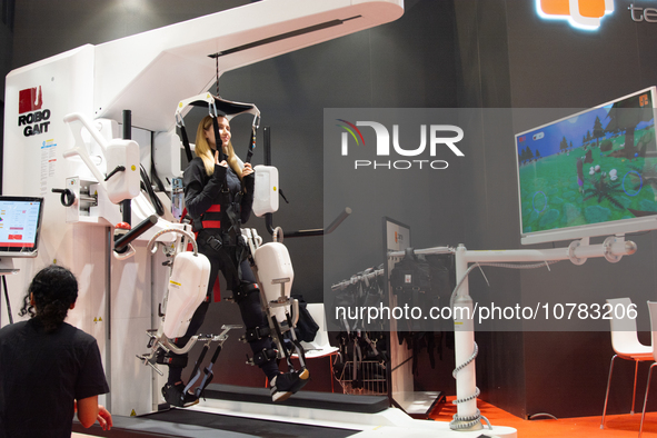 A trade fair attendee is testing a computer-controlled robotic device for walking treatment at the Medica Fair 2023 in Dusseldorf, Germany,...