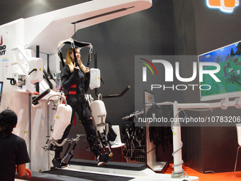 A trade fair attendee is testing a computer-controlled robotic device for walking treatment at the Medica Fair 2023 in Dusseldorf, Germany,...