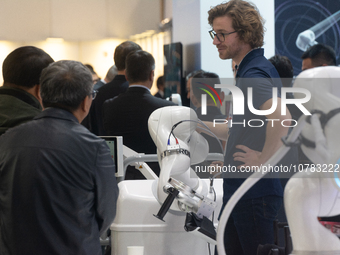 A vendor is demonstrating the robotic arm-assisted system at the Medica Fair 2023 in Dusseldorf, Germany, on November 13, 2023. (