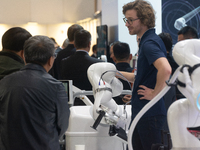 A vendor is demonstrating the robotic arm-assisted system at the Medica Fair 2023 in Dusseldorf, Germany, on November 13, 2023. (