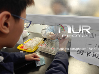 SHANGHAI, CHINA - NOVEMBER 14, 2023 - A doctor draws blood from a patient's finger at a hospital emergency department in Shanghai, China, No...