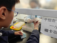 SHANGHAI, CHINA - NOVEMBER 14, 2023 - A doctor draws blood from a patient's finger at a hospital emergency department in Shanghai, China, No...