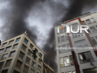 View of fire from the streets of the Historic Center of Mexico City, in the shoe market in Tepito. (