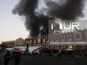 View of fire from the streets of the Historic Center of Mexico City, in the shoe market in Tepito. (