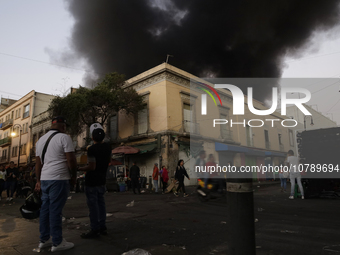 View of fire from the streets of the Historic Center of Mexico City, in the shoe market in Tepito. (