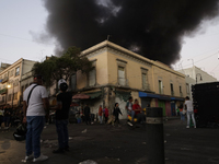 View of fire from the streets of the Historic Center of Mexico City, in the shoe market in Tepito. (