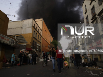 View of fire from the streets of the Historic Center of Mexico City, in the shoe market in Tepito. (