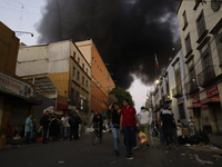 View of fire from the streets of the Historic Center of Mexico City, in the shoe market in Tepito. (