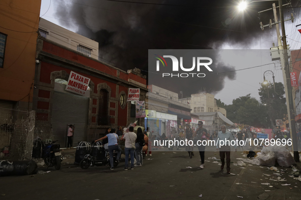 View of fire from the streets of the Historic Center of Mexico City, in the shoe market in Tepito. 