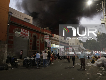 View of fire from the streets of the Historic Center of Mexico City, in the shoe market in Tepito. (