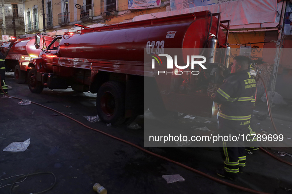 Firefighters get ready to put out a fire in the shoe market in Tepito, Historic Center of Mexico City. 