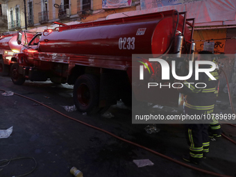 Firefighters get ready to put out a fire in the shoe market in Tepito, Historic Center of Mexico City. (