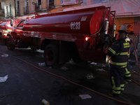 Firefighters get ready to put out a fire in the shoe market in Tepito, Historic Center of Mexico City. (