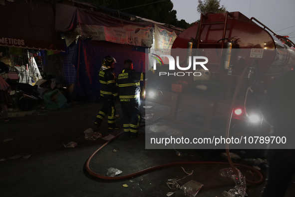 Firefighters get ready to put out a fire in the shoe market in Tepito, Historic Center of Mexico City. 