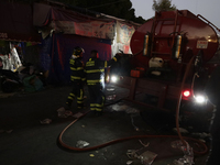 Firefighters get ready to put out a fire in the shoe market in Tepito, Historic Center of Mexico City. (