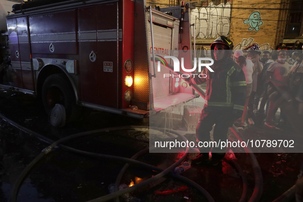 Firefighters get ready to put out a fire in the shoe market in Tepito, Historic Center of Mexico City. 