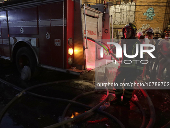 Firefighters get ready to put out a fire in the shoe market in Tepito, Historic Center of Mexico City. (