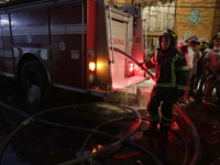 Firefighters get ready to put out a fire in the shoe market in Tepito, Historic Center of Mexico City. (