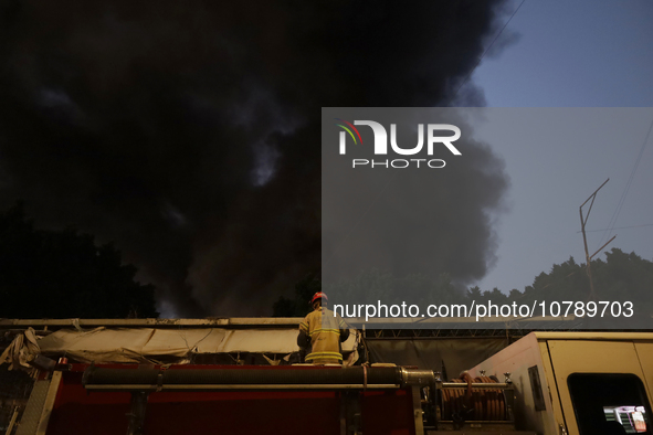 Firefighters get ready to put out a fire in the shoe market in Tepito, Historic Center of Mexico City. 